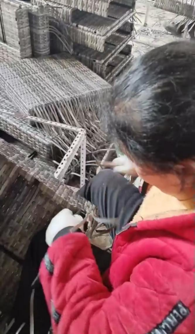 Worker hand weaving an outdoor furniture panel